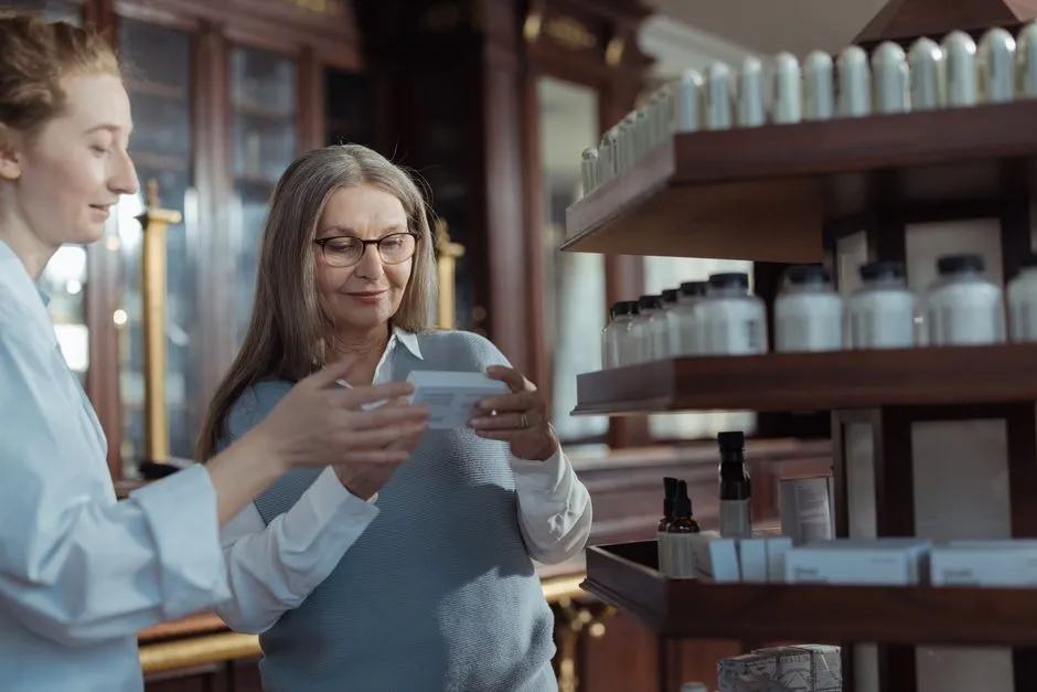 Pharmacist talking an older woman through her medicines
